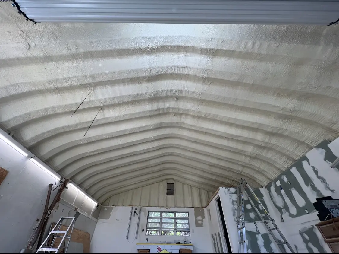 Spray polyurethane foam applied to the underside of a metal roof deck in Leoni